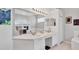 Bright bathroom featuring a double sink vanity, a large mirror, and a walk-in shower at 8718 Grey Oaks Ave, Sarasota, FL 34238