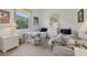 Bright bedroom with twin beds, white dressers, and a sunny window overlooking the landscape at 8718 Grey Oaks Ave, Sarasota, FL 34238