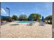 Community pool area featuring a spa, sun loungers, patio furniture, and landscaped surroundings at 8718 Grey Oaks Ave, Sarasota, FL 34238