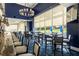 Elegant dining room featuring stylish seating, a modern chandelier, and expansive golf course views at 8718 Grey Oaks Ave, Sarasota, FL 34238