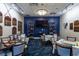 Well-appointed game room with TV, trophies, comfortable seating, and tables for board games at 8718 Grey Oaks Ave, Sarasota, FL 34238
