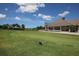 Picturesque golf course view showcasing rolling green hills and the clubhouse in the background at 8718 Grey Oaks Ave, Sarasota, FL 34238