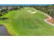 Expansive golf course featuring lush green fairways, pristine white sand bunkers, and meticulously manicured landscapes at 8718 Grey Oaks Ave, Sarasota, FL 34238