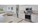 Bright kitchen featuring stainless appliances, light countertops and white cabinets at 8718 Grey Oaks Ave, Sarasota, FL 34238
