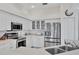Updated kitchen featuring stainless steel appliances, white cabinets, and tile flooring at 8718 Grey Oaks Ave, Sarasota, FL 34238