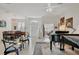 Bright and open-concept living area with a piano and dining table at 8718 Grey Oaks Ave, Sarasota, FL 34238