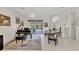 Bright living room with a piano and access to the pool area via sliding glass doors at 8718 Grey Oaks Ave, Sarasota, FL 34238