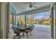 Outdoor patio with a table for six and a view of the beautiful pool and backyard at 8718 Grey Oaks Ave, Sarasota, FL 34238