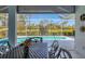 Inviting screened-in pool area with outdoor dining and beautiful golf course views at 8718 Grey Oaks Ave, Sarasota, FL 34238