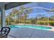 Relaxing screened-in pool offers a private outdoor retreat with serene landscaping at 8718 Grey Oaks Ave, Sarasota, FL 34238