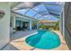 Enjoy outdoor living with a screened lanai with a pool at 8718 Grey Oaks Ave, Sarasota, FL 34238