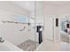 Bright shower and soaking tub featuring custom tile design and modern fixtures at 8718 Grey Oaks Ave, Sarasota, FL 34238