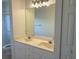 Bathroom featuring a double sink vanity, large mirror, and ample lighting at 902 Addington Ct # 202, Venice, FL 34293