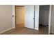 Bedroom featuring wood-look flooring and bright white trim and neutral paint at 902 Addington Ct # 202, Venice, FL 34293