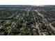 Aerial view of a neighborhood, showcasing lush tree cover and proximity to the coast and downtown at 95 S Briggs Ave, Sarasota, FL 34237