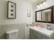 Well-lit bathroom features tiled walls, a framed mirror, and a clean, modern aesthetic at 95 S Briggs Ave, Sarasota, FL 34237
