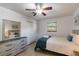 Relaxing bedroom boasts a ceiling fan, a dresser, and bright windows offering a calming and comfortable space at 95 S Briggs Ave, Sarasota, FL 34237