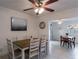 Cozy dining room with tile flooring, natural light, and an open view to the kitchen and additional living spaces at 95 S Briggs Ave, Sarasota, FL 34237
