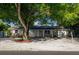 Charming single-story home with a gravel front yard and mature shade trees enhancing curb appeal at 95 S Briggs Ave, Sarasota, FL 34237