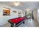 Spacious game room with a pool table and seamless flow to the outdoor dining area makes this home an entertainer's dream at 95 S Briggs Ave, Sarasota, FL 34237
