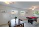 Bright game room boasts a billiard table, tile floors, and natural light streaming through the windows at 95 S Briggs Ave, Sarasota, FL 34237