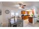 Bright kitchen with wood cabinets, tile floors, and a connected dining area provides a seamless space for cooking and entertaining at 95 S Briggs Ave, Sarasota, FL 34237
