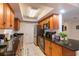 Well-lit kitchen features dark countertops, ample cabinet space, stainless appliances, and modern tile flooring at 95 S Briggs Ave, Sarasota, FL 34237