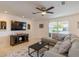 Cozy living room featuring a large sectional sofa, tile flooring, and a view of the landscaped front yard at 95 S Briggs Ave, Sarasota, FL 34237
