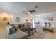 Comfortable living room with a sectional sofa, tiled floors, and an open layout leading to the dining area and kitchen at 95 S Briggs Ave, Sarasota, FL 34237