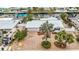 Aerial view of home with landscaping and paved driveway and mature palm trees at 10308 Kingfisher W Rd, Bradenton, FL 34209