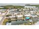 High angle aerial capturing a waterfront neighborhood, showing homes situated along winding canals with boat docks at 10308 Kingfisher W Rd, Bradenton, FL 34209