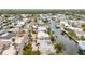 Aerial capturing a waterfront community, with homes along canals, private docks, and immediate boating access at 10308 Kingfisher W Rd, Bradenton, FL 34209