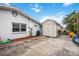 View of the backyard with concrete and a storage shed against the house at 10308 Kingfisher W Rd, Bradenton, FL 34209