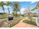 Backyard view of a grill and the canal with palm trees at 10308 Kingfisher W Rd, Bradenton, FL 34209