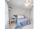 Bedroom with neutral walls, tan tile floor, shelving, and decorative trim at 10308 Kingfisher W Rd, Bradenton, FL 34209