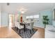 Well-lit dining area with a stylish table setting and seamless access to other rooms at 10308 Kingfisher W Rd, Bradenton, FL 34209
