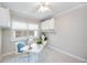 Home office with neutral walls, tan tile floor, bright window and built-in storage at 10308 Kingfisher W Rd, Bradenton, FL 34209