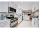 Clean kitchen offering white cabinets, modern appliances, and a convenient breakfast bar at 10308 Kingfisher W Rd, Bradenton, FL 34209