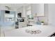 Bright kitchen features white cabinets, stainless steel appliances, and light countertops at 10308 Kingfisher W Rd, Bradenton, FL 34209