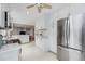 Modern kitchen showcases white cabinets, stainless steel refrigerator, and ample counter space at 10308 Kingfisher W Rd, Bradenton, FL 34209