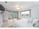 Bright main bedroom with tan tile floor, patio access, and window overlooking canal at 10308 Kingfisher W Rd, Bradenton, FL 34209