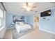 Light-filled bedroom has tile floors, ceiling fan, and leads into an en-suite bathroom at 10308 Kingfisher W Rd, Bradenton, FL 34209