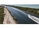 Aerial view of a white boat speeding along a blue waterway near Sarasota, Florida, under a sunny sky at 1156 Lemon Bay Dr, Venice, FL 34293