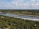 An aerial view features waterways weaving past dense trees, ideal for outdoor adventures and waterfront property at 1156 Lemon Bay Dr, Venice, FL 34293
