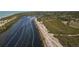 Aerial view showcases a river alongside green land and scenic trails, inviting exploration and appreciation at 1156 Lemon Bay Dr, Venice, FL 34293