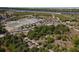 Aerial view of sports facilities including tennis and basketball courts adjacent to Lemon Bay at 1156 Lemon Bay Dr, Venice, FL 34293