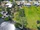 Aerial view of a waterfront property with private dock, lush greenery, and serene access to the water at 1156 Lemon Bay Dr, Venice, FL 34293