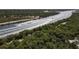 An aerial view of waterway and boats winding through lush greenery, promising scenic waterfront enjoyment at 1156 Lemon Bay Dr, Venice, FL 34293