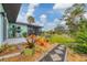 Picturesque backyard featuring lush landscaping, a screened patio, and serene outdoor space at 1156 Lemon Bay Dr, Venice, FL 34293