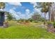 Expansive backyard with well-maintained lawn and mature trees, offering a tranquil outdoor space at 1156 Lemon Bay Dr, Venice, FL 34293